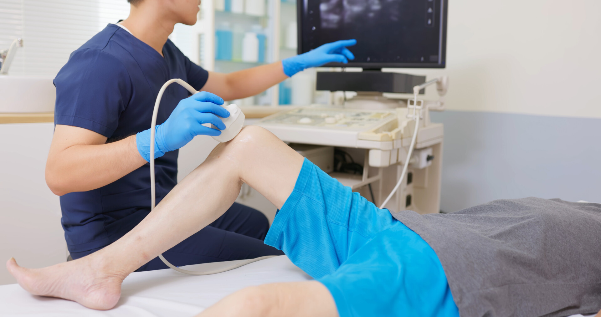 Asia Doctor Perform Knee Ultrasound